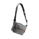 Peak Design Everyday Sling in ash color, compact camera and daily essentials sling bag with adjustable strap and multiple pockets.