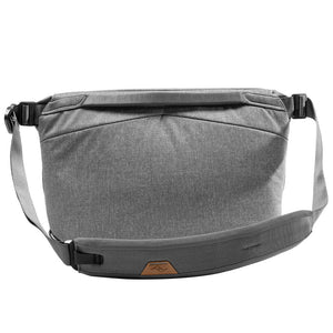 Peak Design Everyday Sling in ash color, showing the compact design with adjustable strap and multiple compartments for organization.