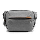 Peak Design Everyday Sling in ash color, compact sling bag with adjustable strap and multiple compartments for everyday carry.