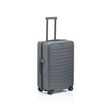 Matte black Porsche Design Roadster 27-inch expandable spinner luggage with four wheels and sleek modern design.