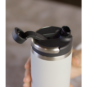 Black Purist Founder 32oz water bottle with a sleek design and secure cap, ideal for staying hydrated on the go.