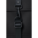Black Rains Mini backpack with sleek design, featuring a compact shape, adjustable straps, and subtle branding on the front.
