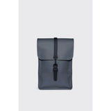 Rains Mini backpack in river blue color, compact design with adjustable straps and front zip pocket, made of waterproof material.