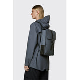 Rains Mini backpack in river blue with adjustable straps and compact design, perfect for daily use.