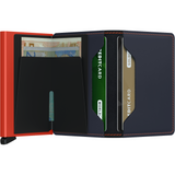 Open Secrid Slimwallet in matte night blue with orange accents, showing card slots and compact design.