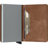 Secrid Slimwallet in vintage cognac leather with silver accents, semi-open view showing card slots and compact design.