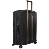 Black Thule Crossover 2 carry-on spinner luggage with four wheels and built-in handle, designed for travel convenience.