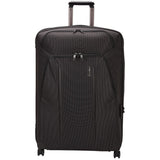 Black Thule Crossover 2 Carry-On Spinner luggage with four wheels and retractable handle, designed for easy travel.