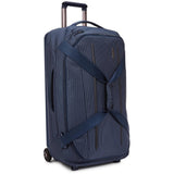 Thule Crossover 2 Wheeled Duffel 30-inch black luggage with sturdy wheels, retractable handle, and spacious main compartment.