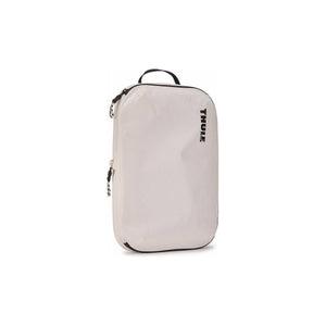 Medium Thule compression packing cube used for organizing clothes and accessories in luggage or travel bags.