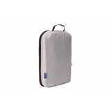 Medium Thule compression packing cube for organizing clothing, featuring multiple compartments and durable fabric.