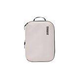 Medium Thule compression packing cube for organizing clothes and gear, featuring durable fabric and secure zipper closure.