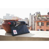 Topo Designs accessory bag in natural fabric with zipper closure, compact storage for small essentials.
