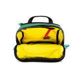 Topo Designs Subalpine Hip Pack waist pack with adjustable strap and multiple compartments, shown in forest green.