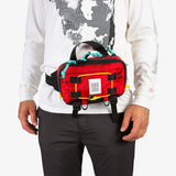 Red Topo Designs Subalpine Hip Pack waist pack with adjustable strap and multiple compartments for outdoor adventures.
