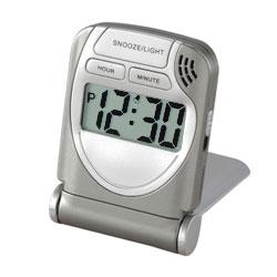 Voltage Valet LCD Travel Alarm Clock showing time, compact design, and travel essentials features for easy portability.